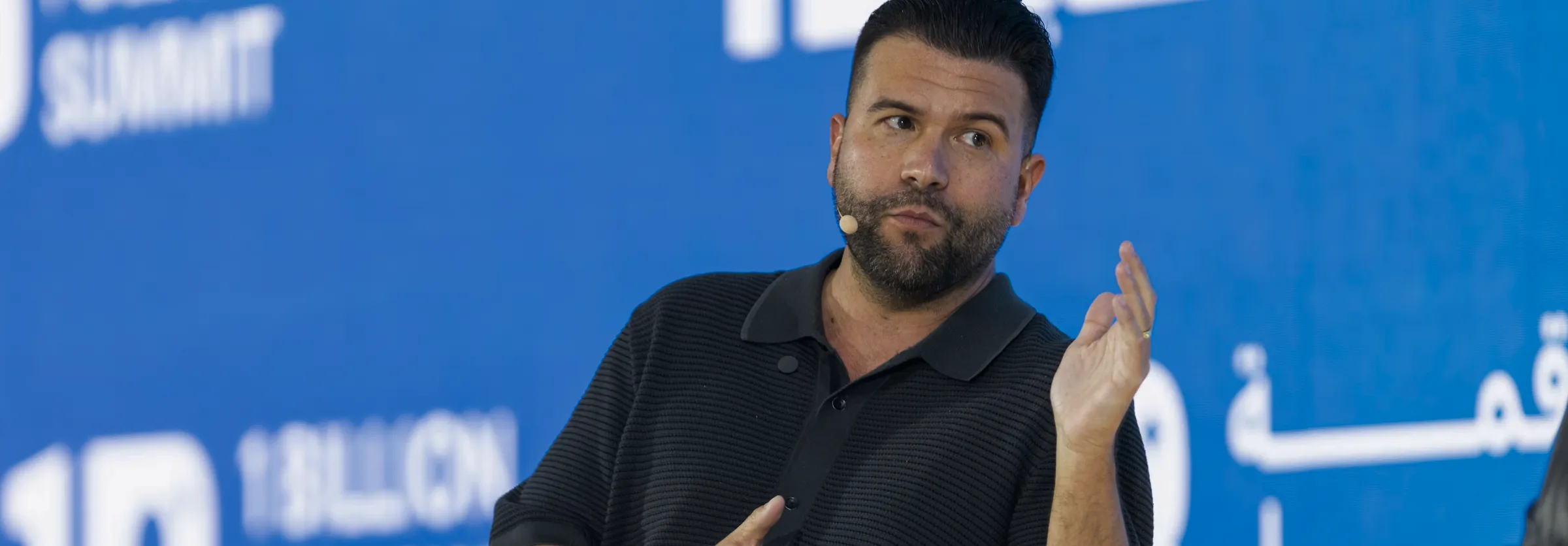 A consultant speaking on stage at a conference