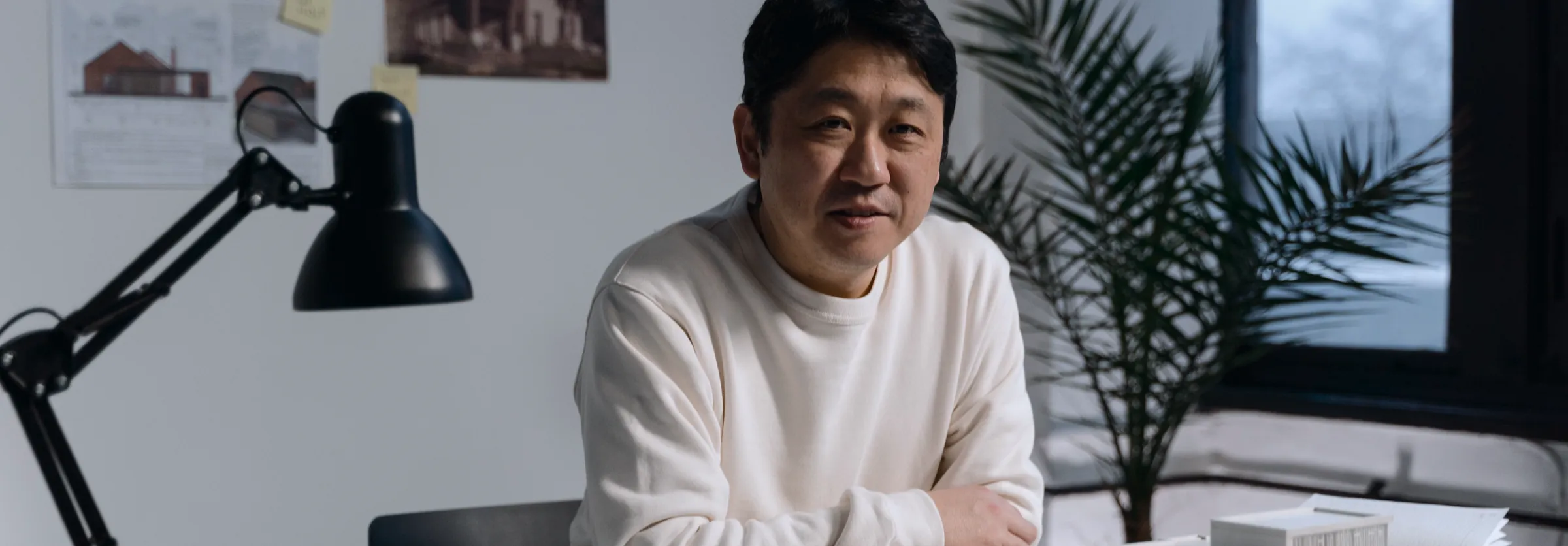 An executive speaking on a video call at a desk