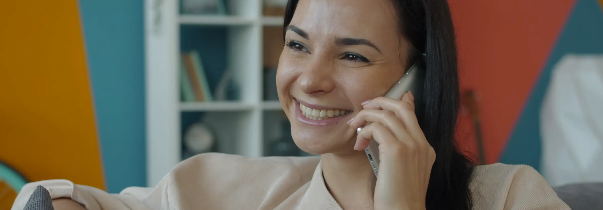 A salesperson smiling during a phone call
